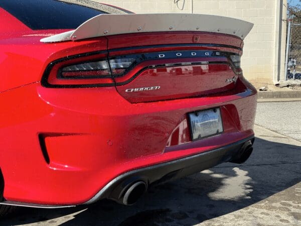 The rear end of a red dodge charger