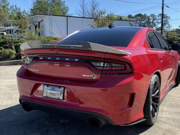 A red car parked in a parking lot