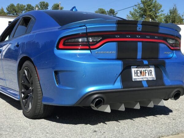Rear view of a blue Dodge Charger Hellcat featuring a wind diffuser and a license plate reading "HEMIFVR."
