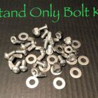 A collection of bolts, nuts, and washers labeled "Stand Only Bolt Kit" on a dark background.