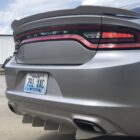 Silver Dodge Charger rear view with distinctive taillights and a custom rear diffuser. Kentucky license plate visible.