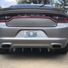Silver Dodge Charger rear view, featuring dual exhaust and a rear diffuser. Kentucky license plate visible.