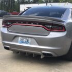 Silver Dodge Charger parked with a rear diffuser and visible license plate.