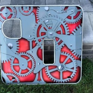 A decorative panel featuring gray gears on a red background, with cutouts in two corners.