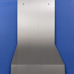 Metal transmission cover plate with mounting holes, placed against a blue background.