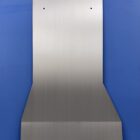Metal transmission cover plate with multiple holes, set against a blue background.