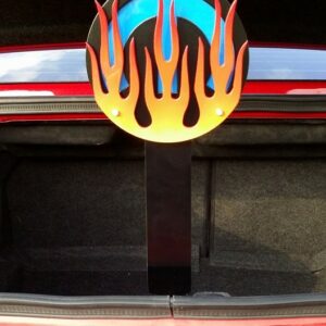 A decorative trunk prop features a circular design with blue and orange flames.