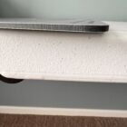 Close-up of a foam core board resting on a surface, showing its edge and texture.